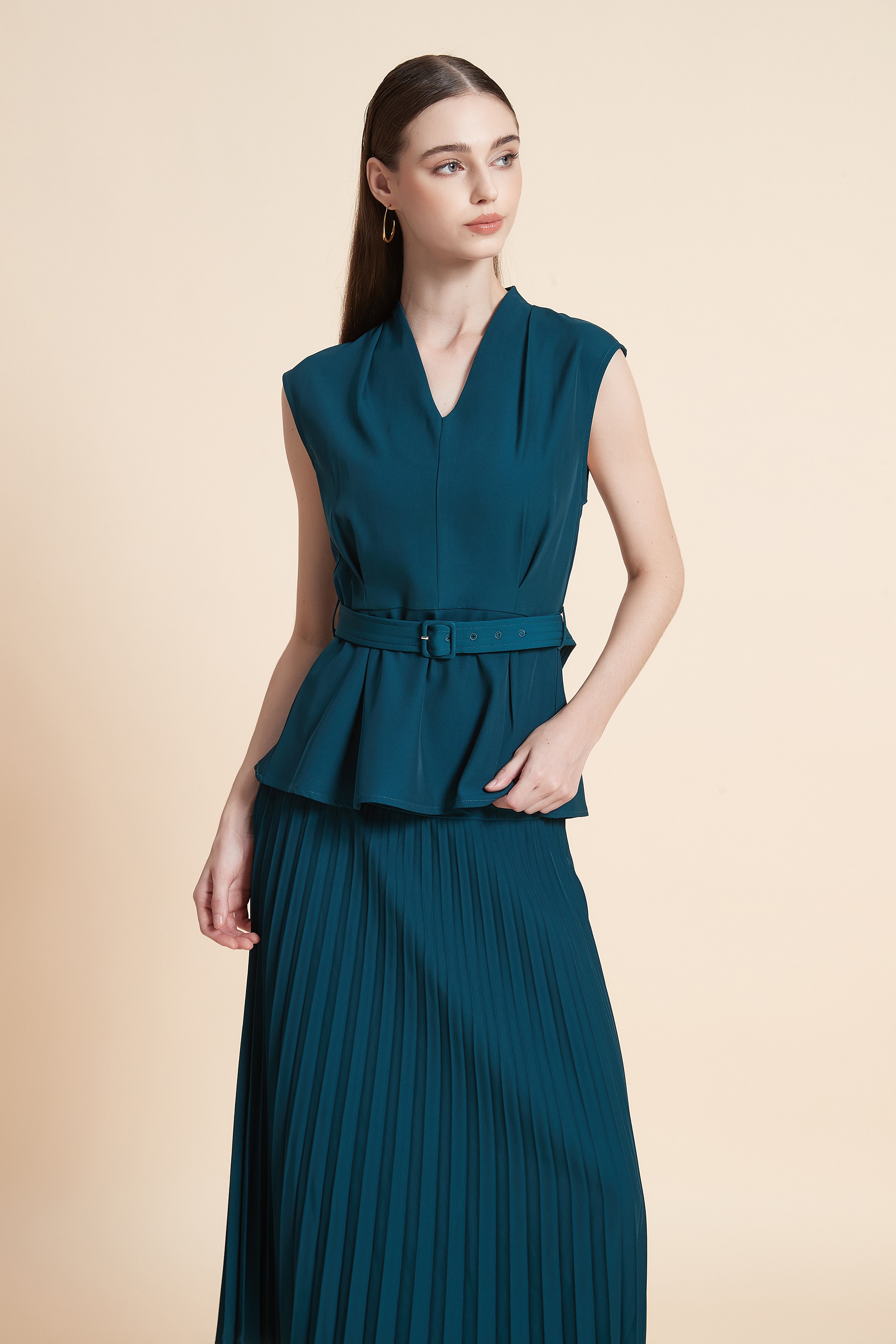Sleeveless peplum top with a belt