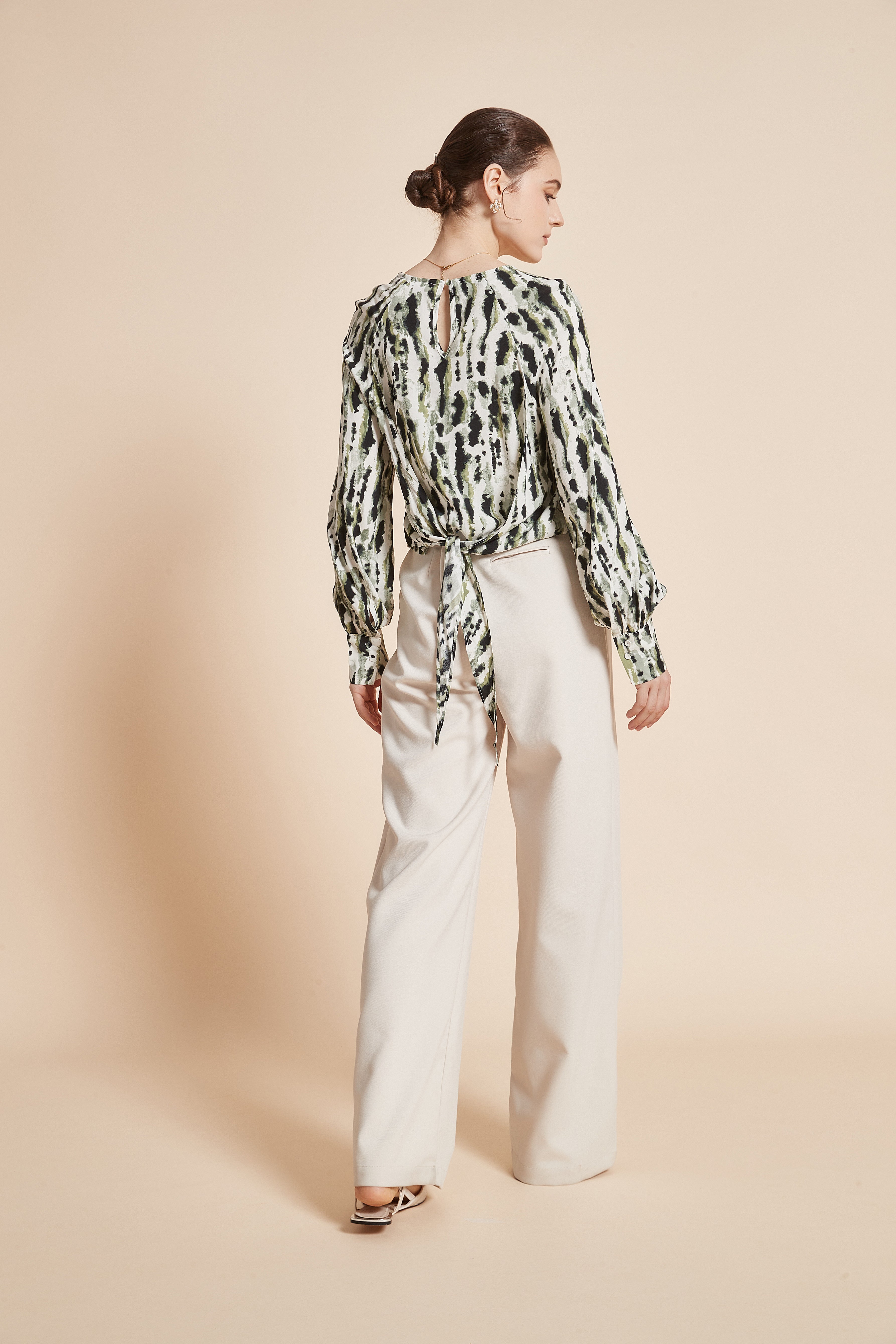 Striped blouse with vertical colors, long wide sleeves, and a round neckline