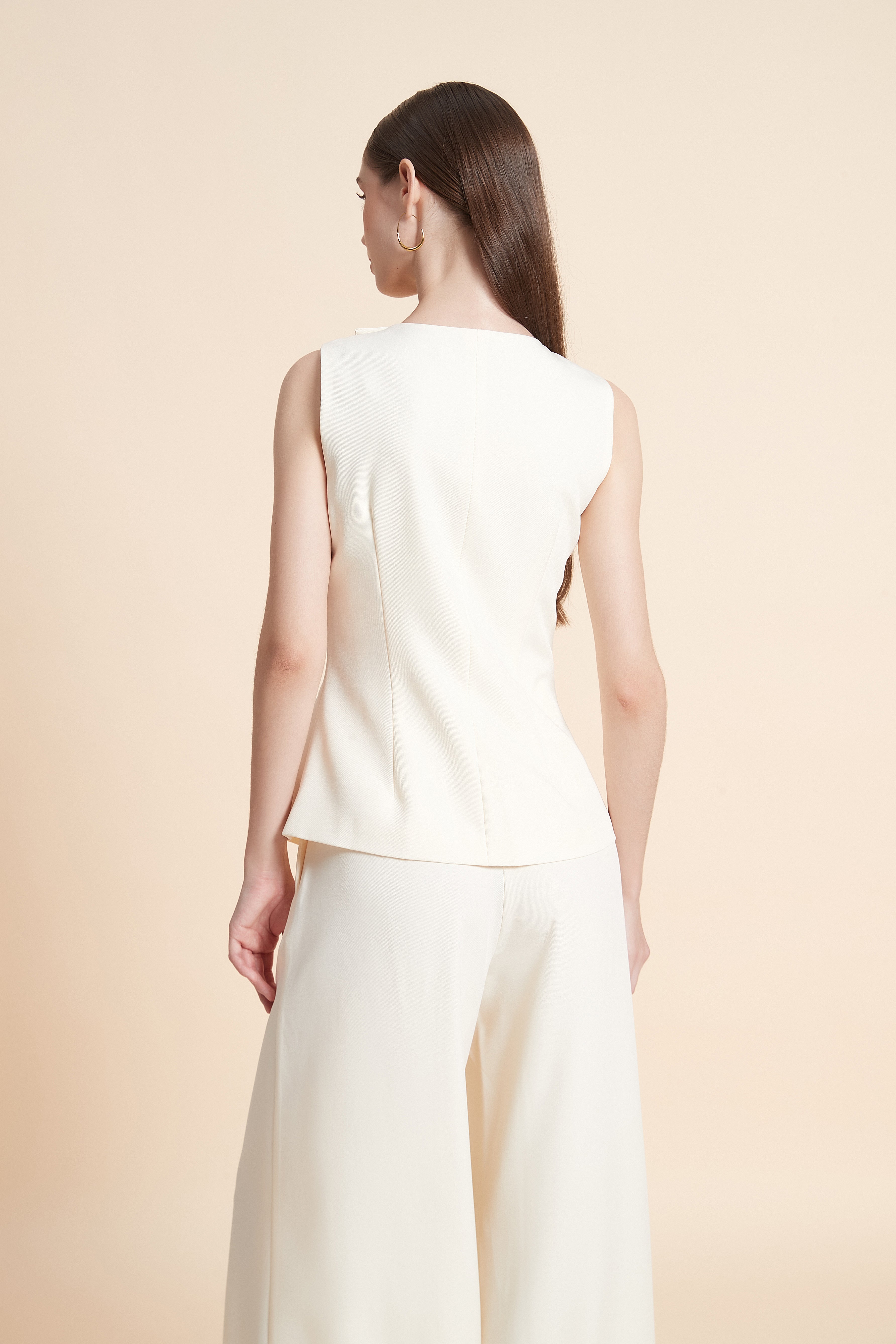 Peplum vest with asymmetrical buttons