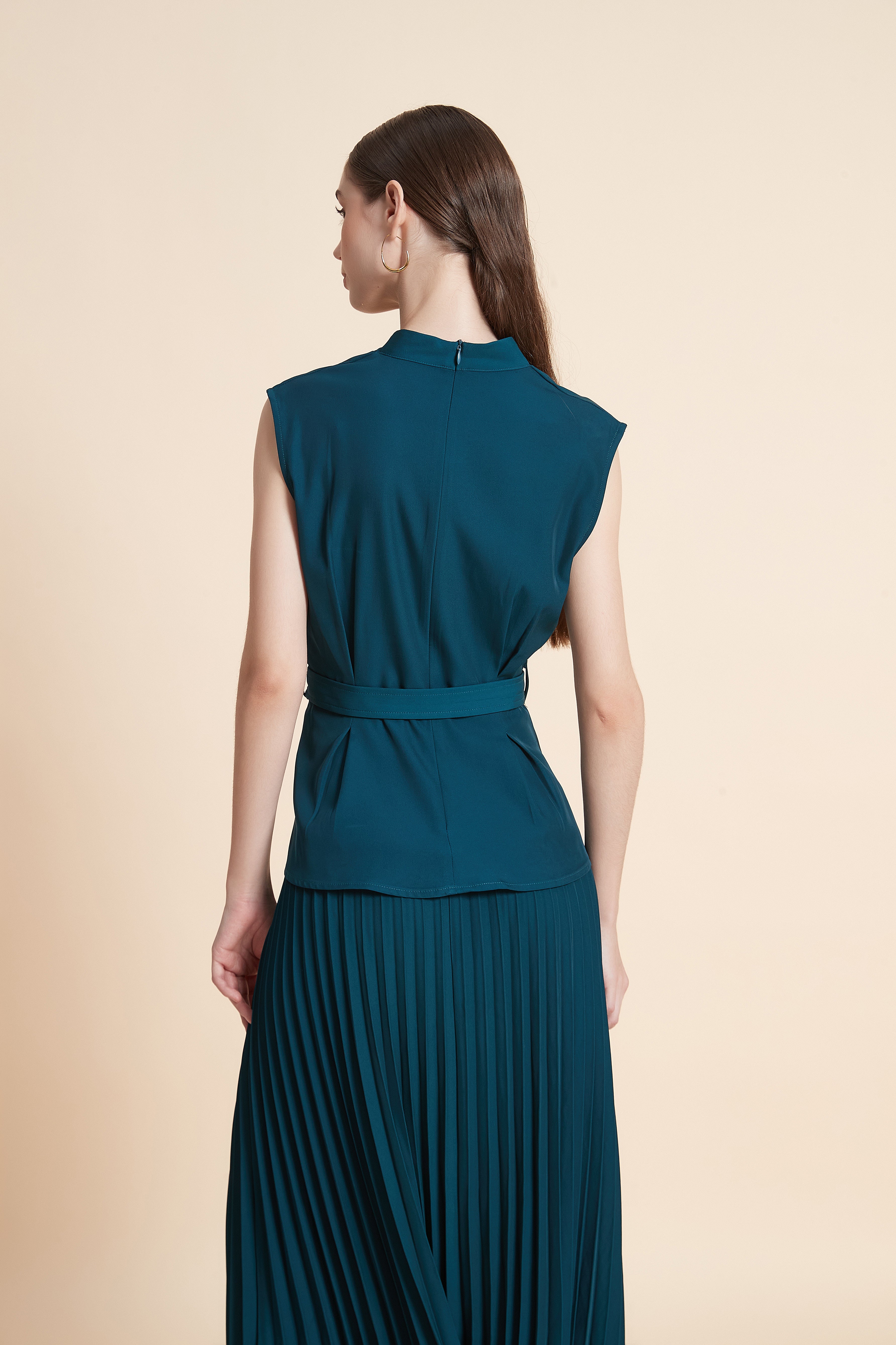 Sleeveless peplum top with a belt