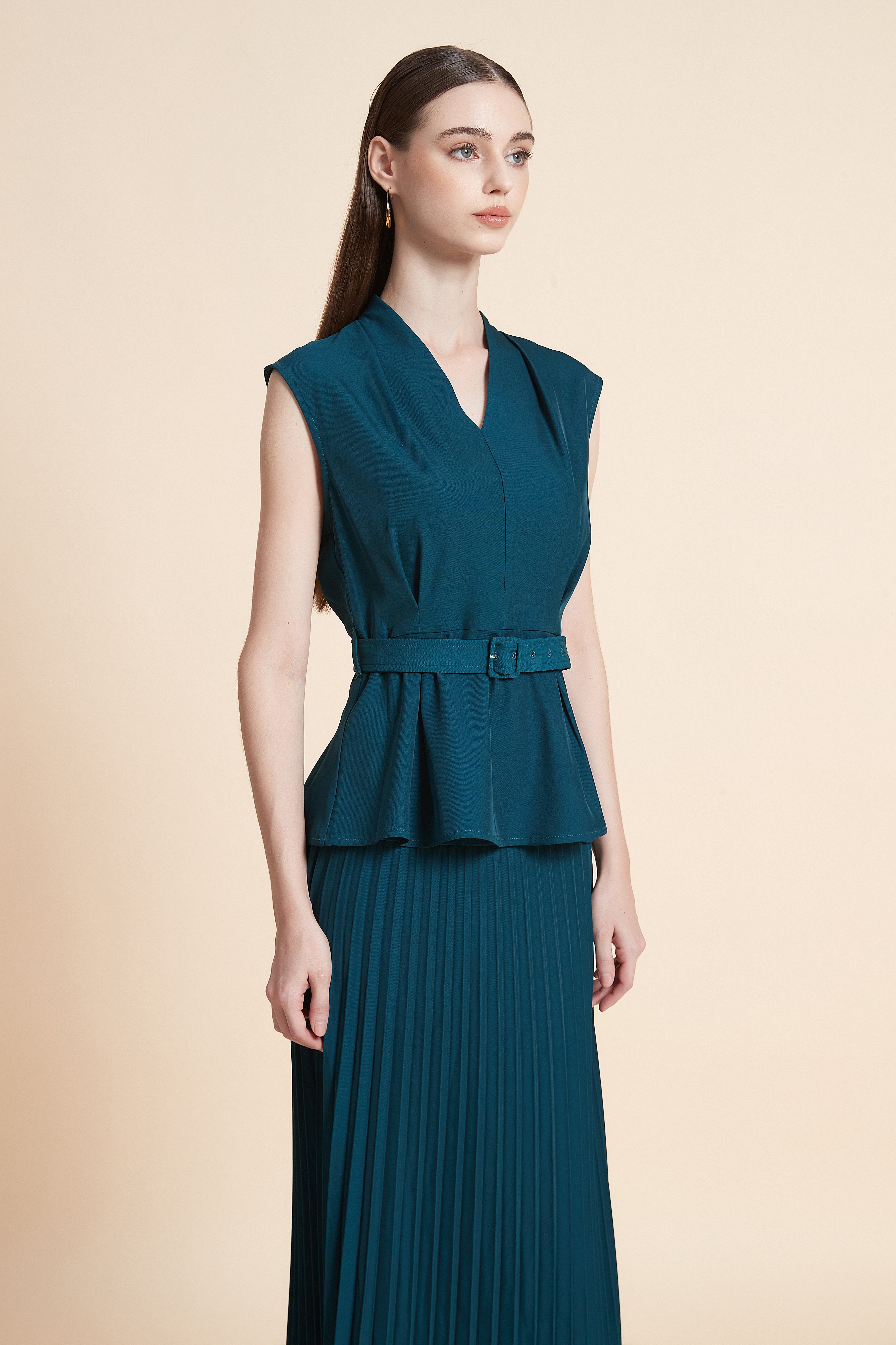 Sleeveless peplum top with a belt