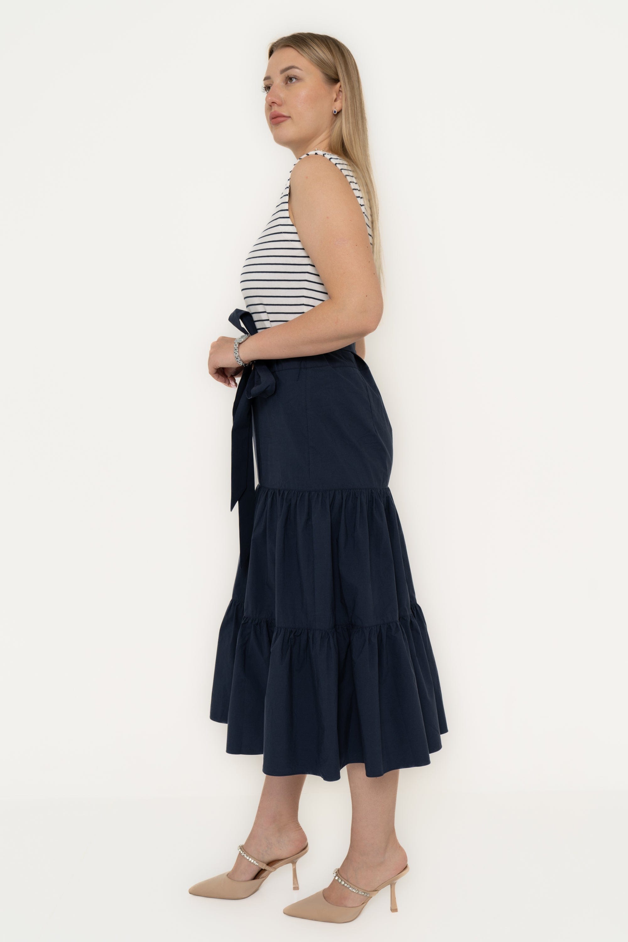 Yola Dress with half horizontal stripes and half solid color, featuring a ruffled design and a tie waist