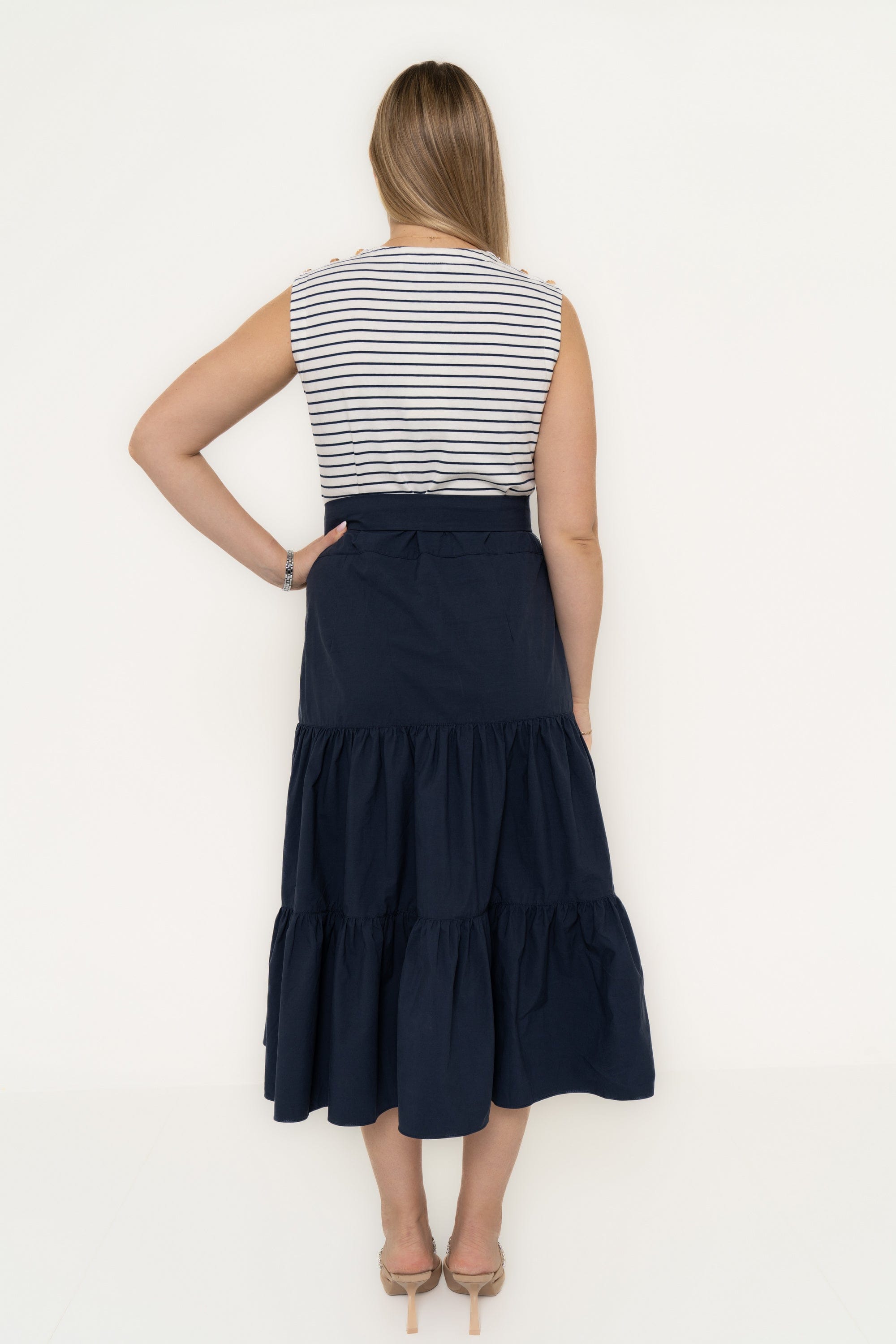 Yola Dress with half horizontal stripes and half solid color, featuring a ruffled design and a tie waist